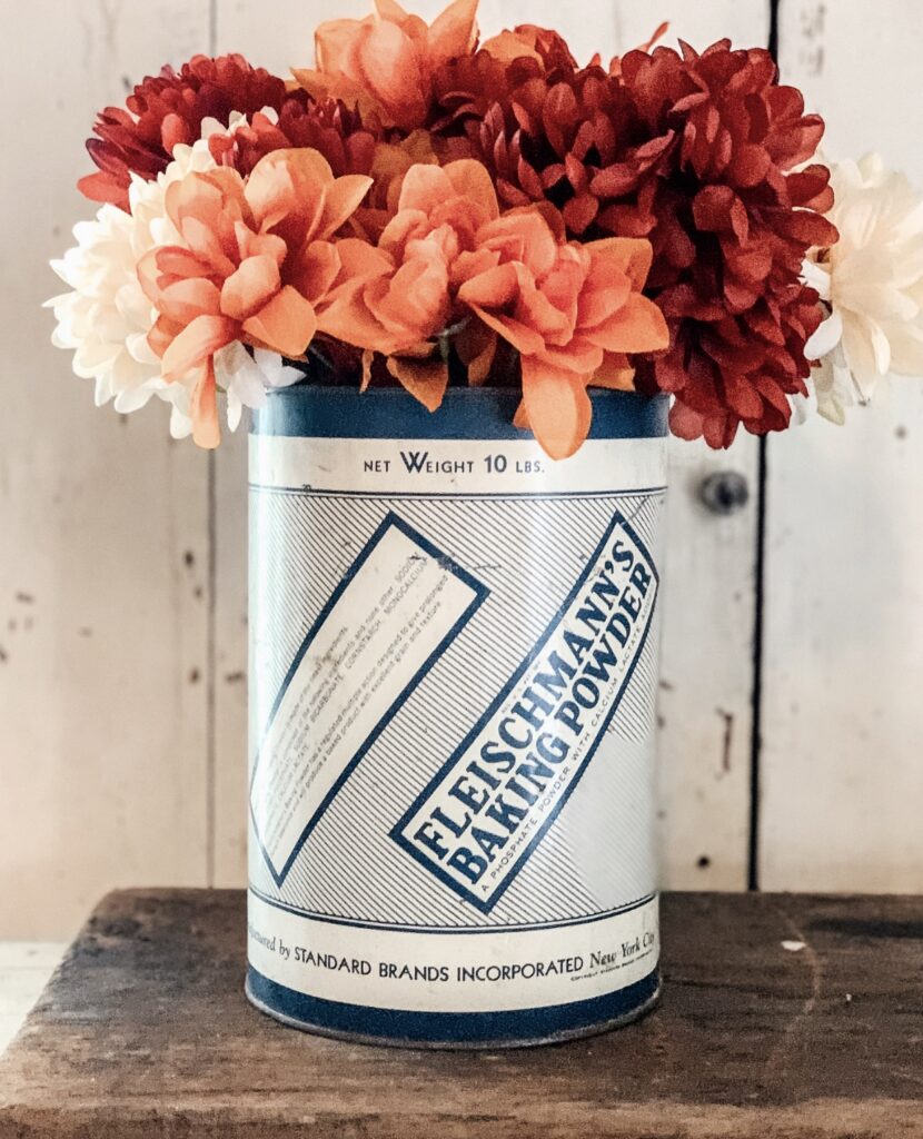A vintage tin can filled with Fall Flowers.