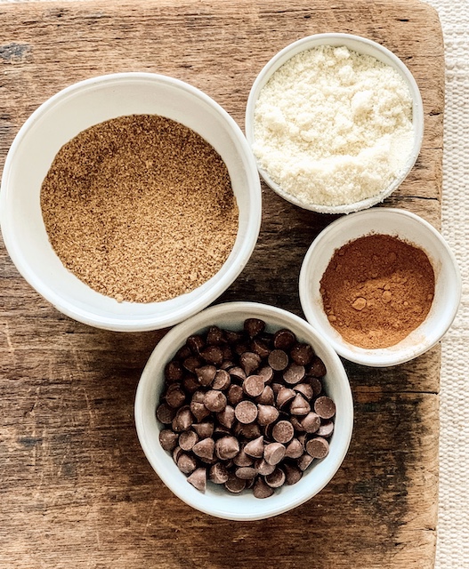 Four bowls full of ingredients for the Paleo Snickerdoodle Cookie recipe.