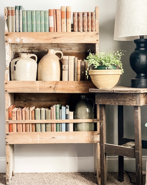 An antique bookcase filled with old books.