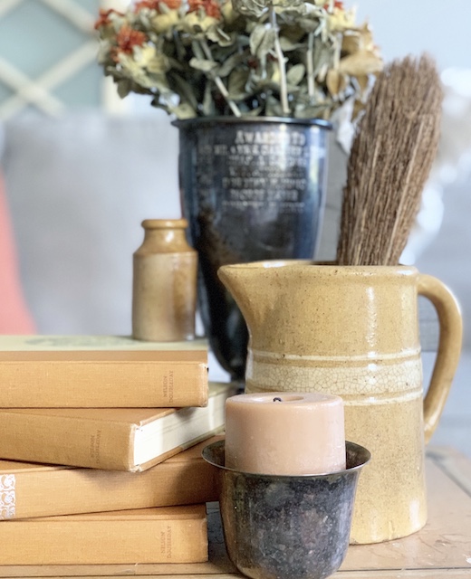 A bunch of vintage items on a table for fall decor