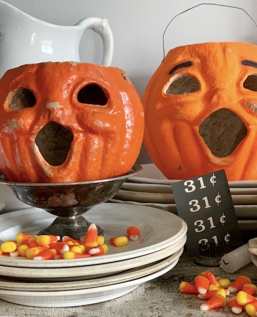 two paper mache pumpkins sitting on a table