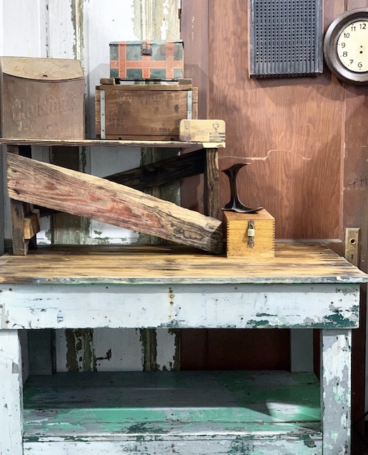 an old work bench with a few pieces on top
