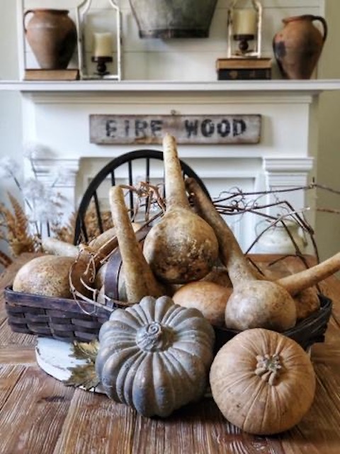 A table with fall gourds on it.