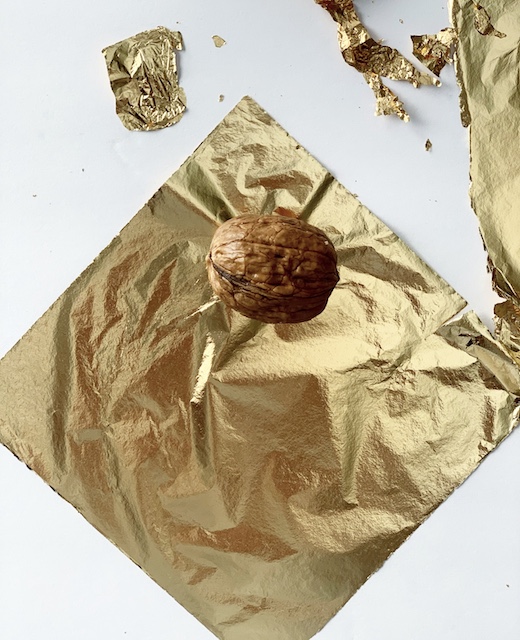 walnut waiting to be wrapped in gold lesf