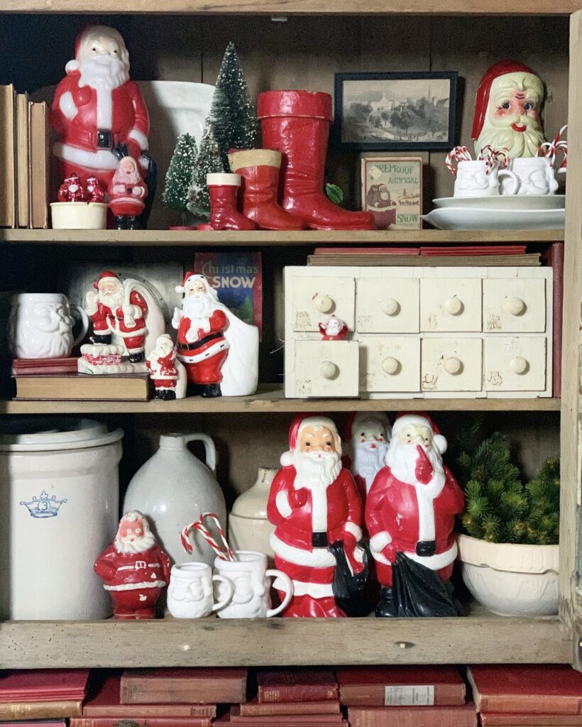 old cabinet filled with old Santas