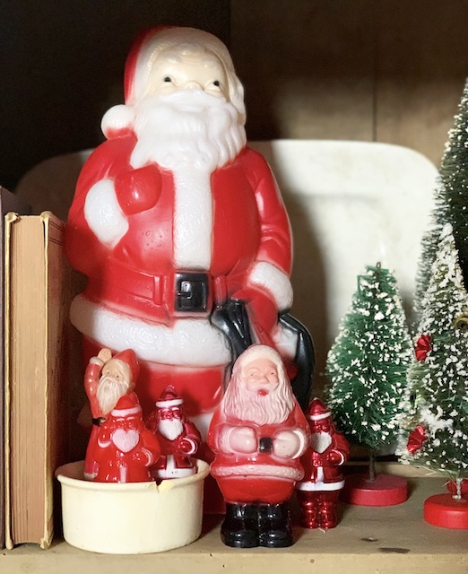 collection of old santas on a shelf