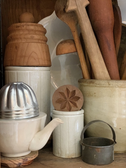 wooden butter molds displayed on a shelf