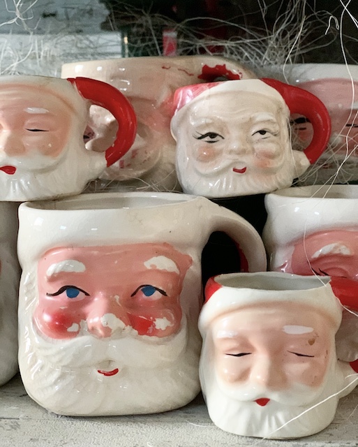 a handful of Santa Mugs on a table