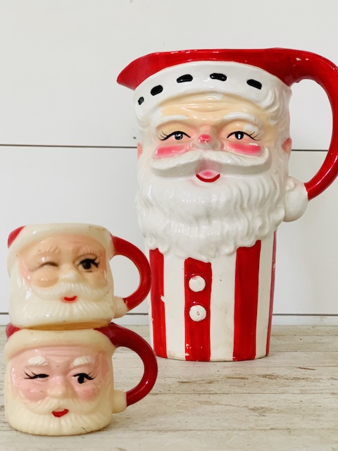 two smaller plastic santa mugs