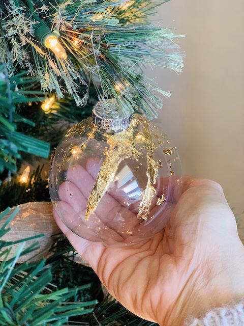my hand holding a gilded ornament