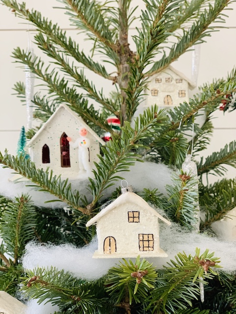 putz house white tucked inside a stubby christmas tree