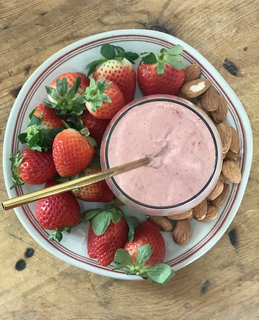 smoothie, strawberries, and almonds on a plate