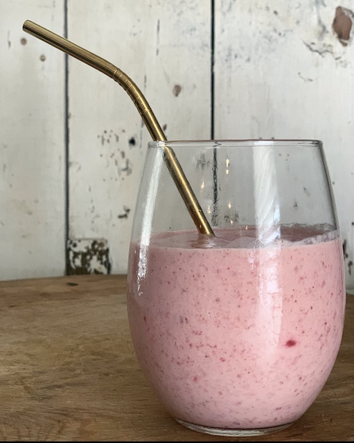 a smoothie with a gold straw