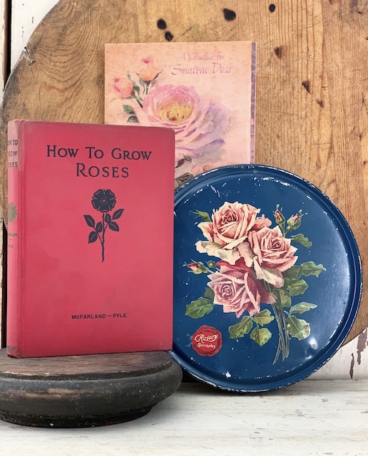 a book and tin and card with a rose on it