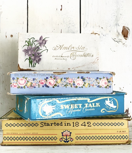 a stack of vintage candy boxes for valentine decor