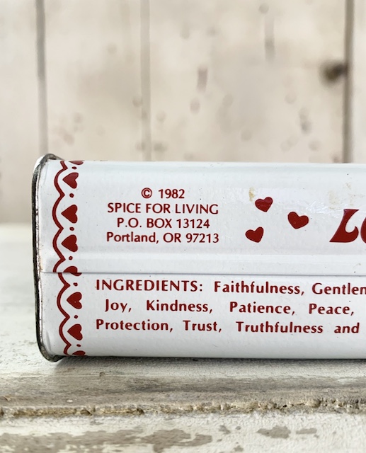 a close up of a date on the heart spice tin - 1982