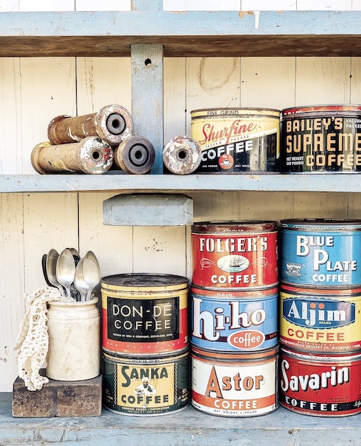A display of old coffee cans