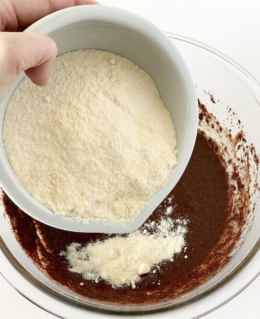 a photo of me adding coconut flour into the batter