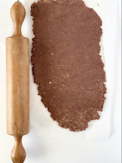 a rolling pin and a flattened out dough for paleo valentine mint cookies