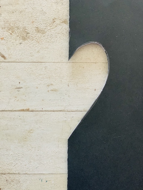 1/2 heart cut out of cardboard