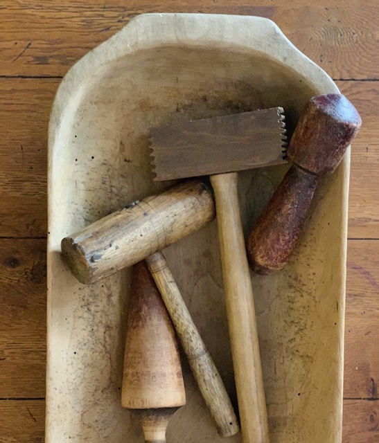 a wooden bowl filled with mallets wooden