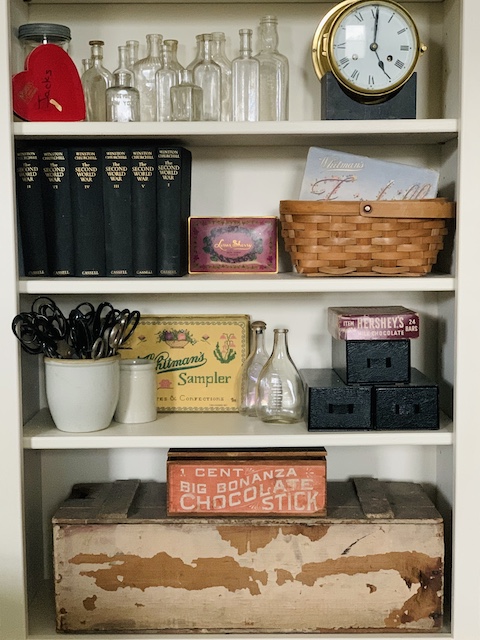 vintage candy boxes displayed on a bookcase