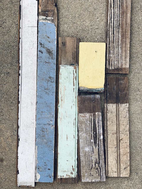 pieces of old salvaged wood laying in the driveway