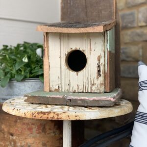 homemade birdhouse on front porch
