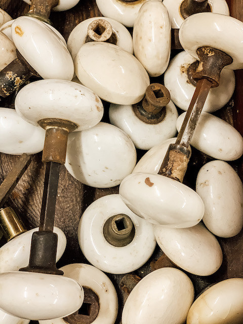 a bunch of old knobs in a bin