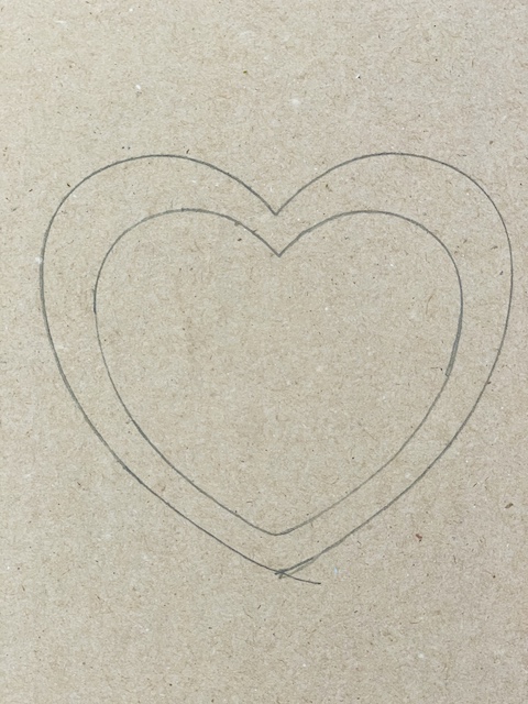a heart traced on card board