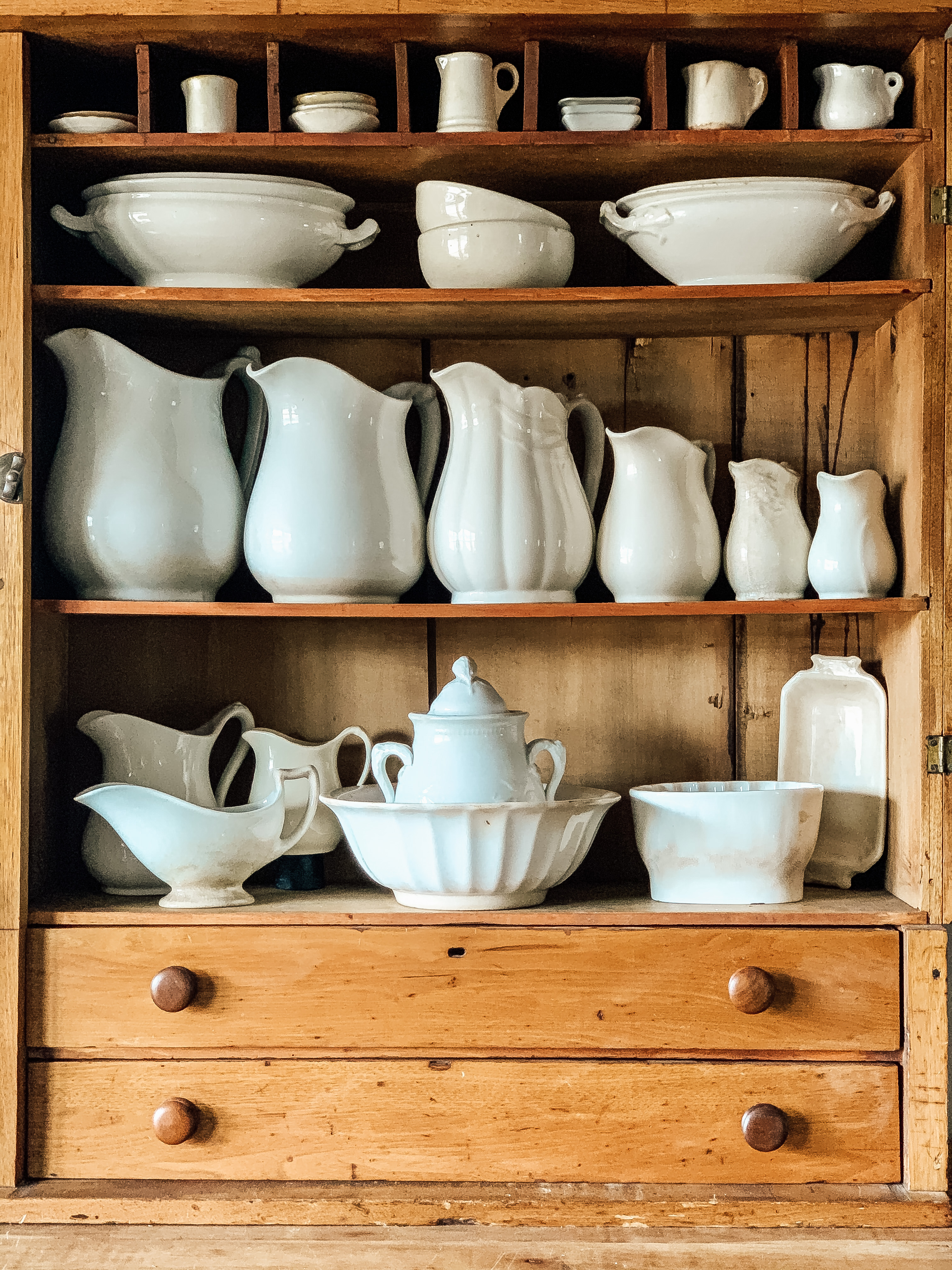 a cabinet full of ironstone