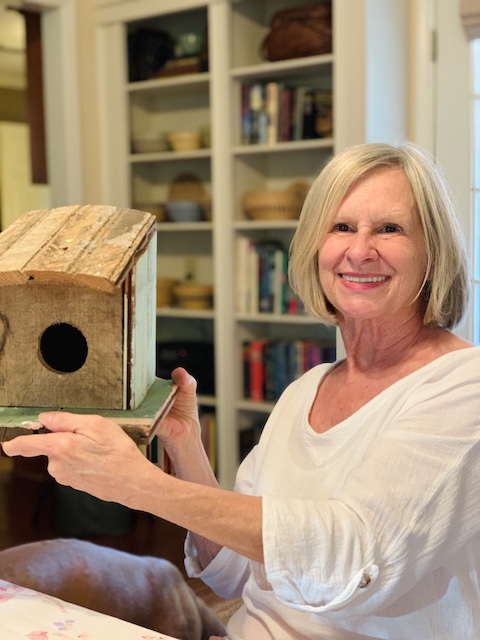 my mom holding a bird house that Mark made