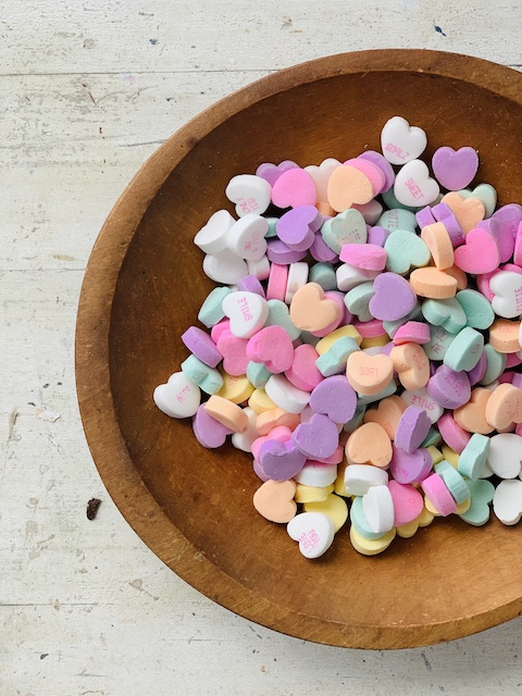 conversation hearts in a wooden bowl