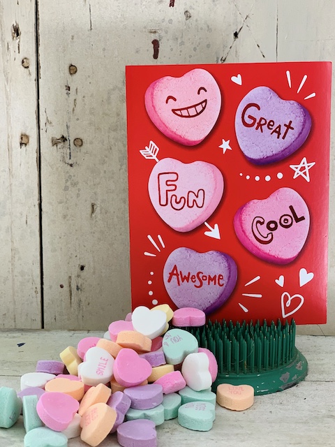 conversation hearts with a card next to them