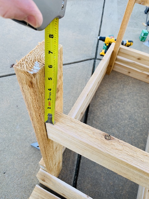 measuring the length of a board for a raised garden box
