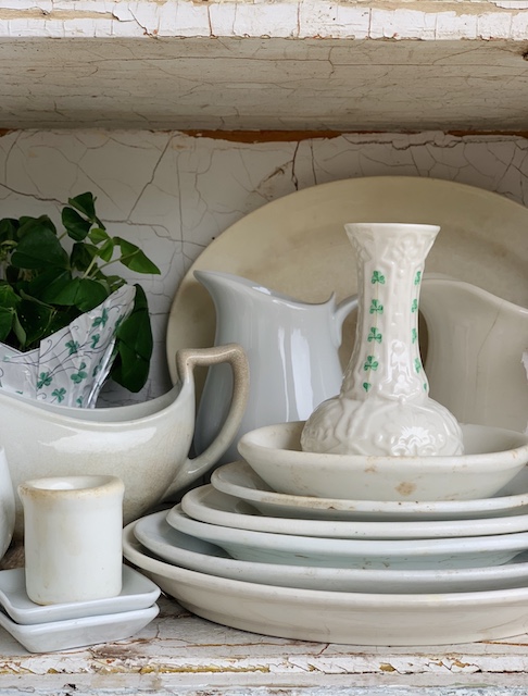 clover vase on top of a stack of dishes