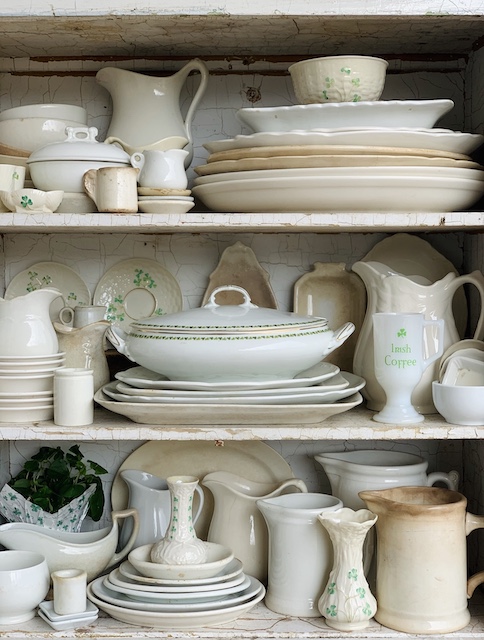 vintage saint patrick's day decor dishes all piled into a cupboard