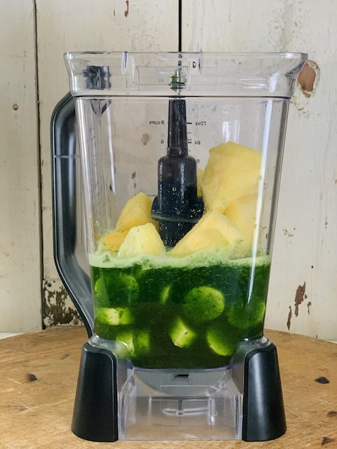 ingredients for the best green smoothie sitting in a blender