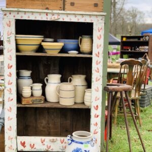 heart sponged cabinet full of blue stoneware at the sale