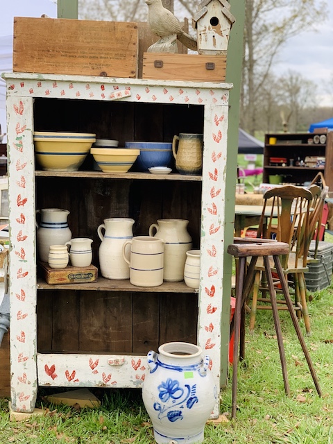 heart sponged cabinet full of blue stoneware at the sale