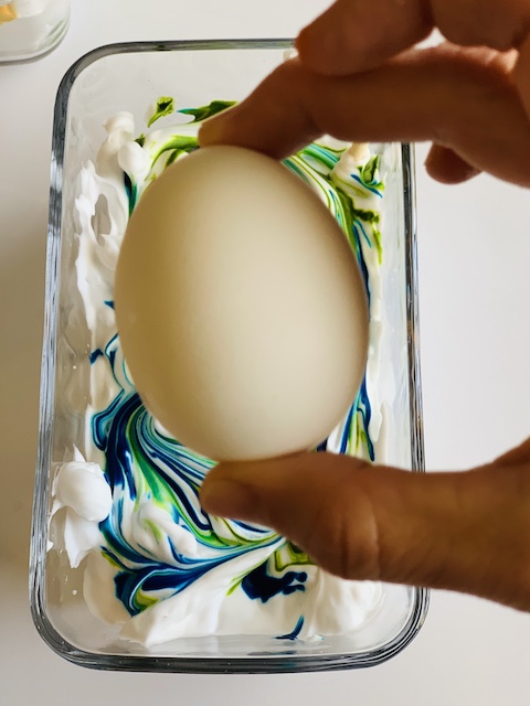 dropping hard boiled egg into the shaving cream