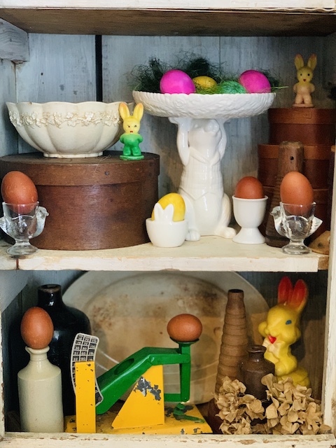 my shaving cream eggs all styled on a shelf with other easter decor