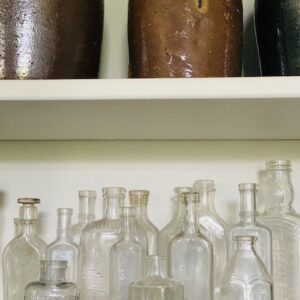 little bottles all cleaned sitting on a shelf