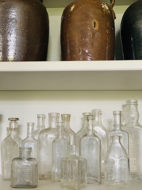 little bottles all cleaned sitting on a shelf