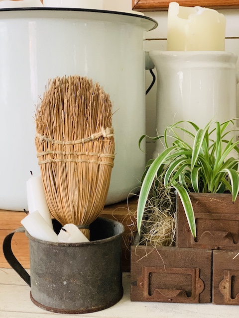 whisk broom styled in a cup