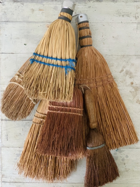 a pile of brooms