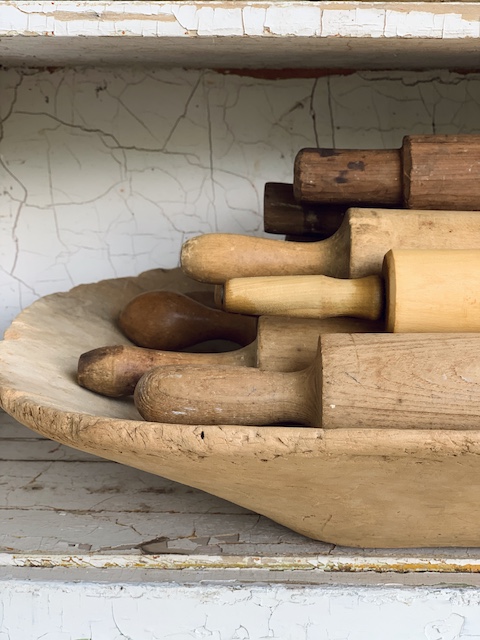 wooden bowl full of old rolling pins
