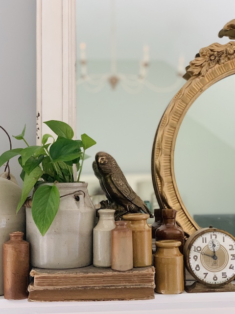mirror and brass bird on a mantle