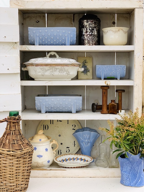 blue and white vintage items in. cupboard