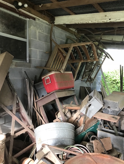 a pile of junk beside a shed